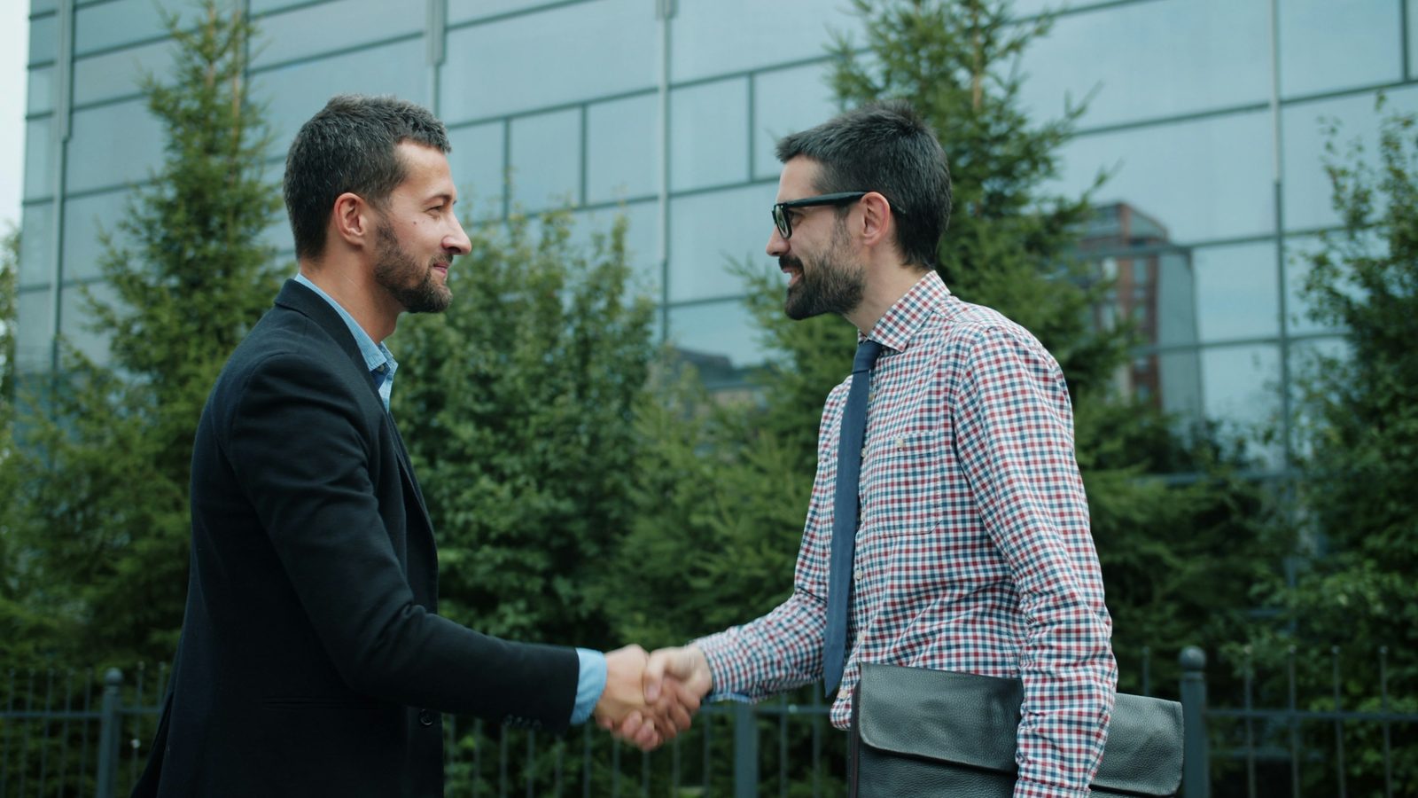 Professional handshake outside an office building